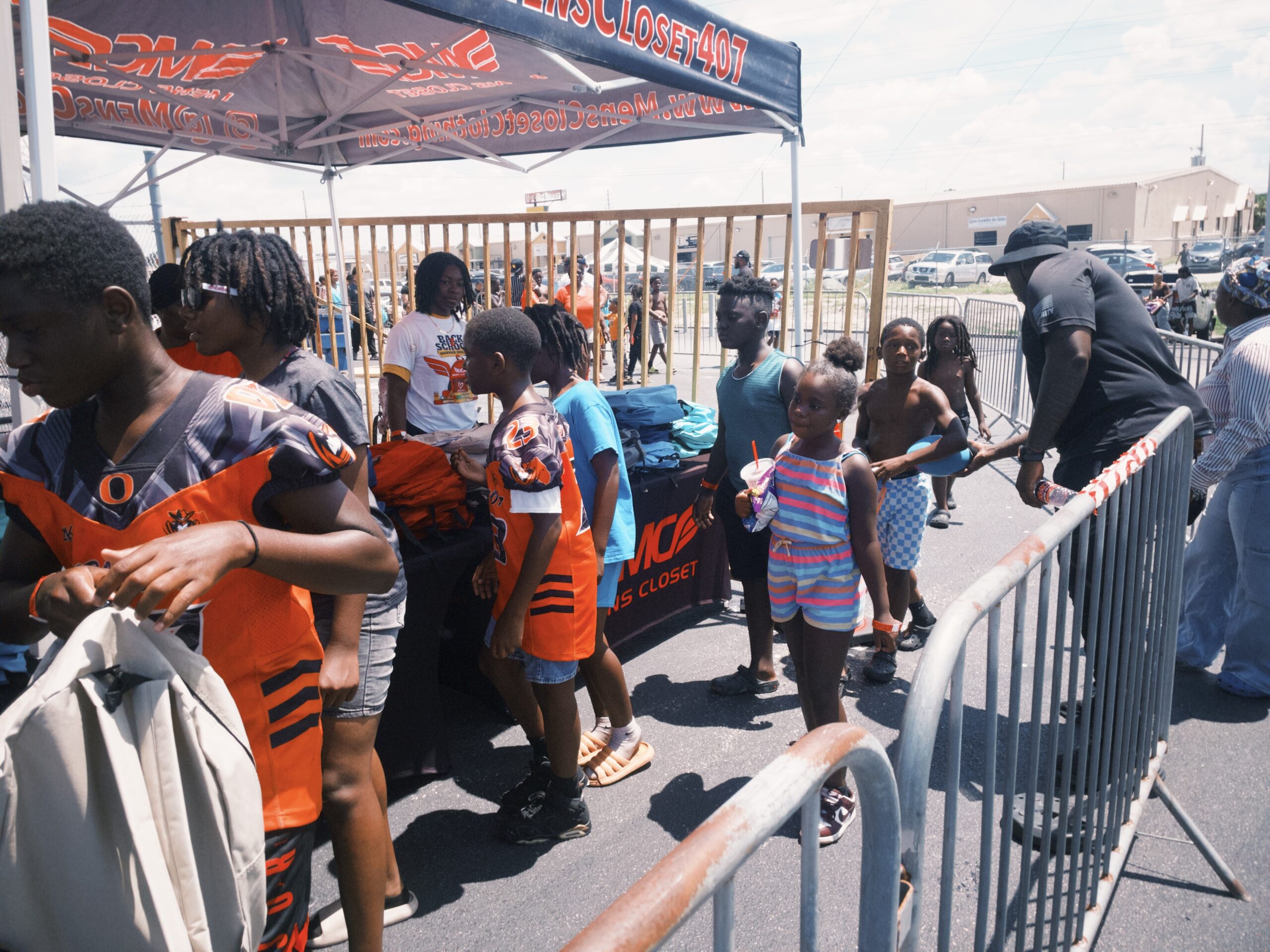 Kids lining up to get backpacks