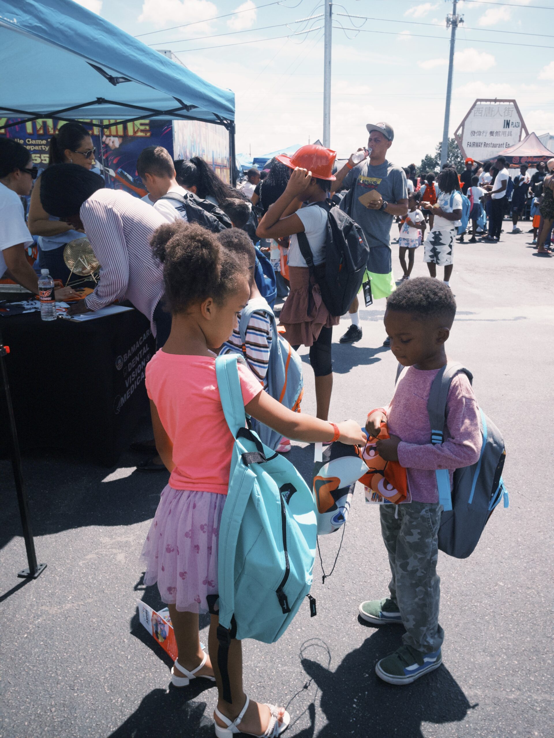 Girl and Boy talking after receiving backpacks