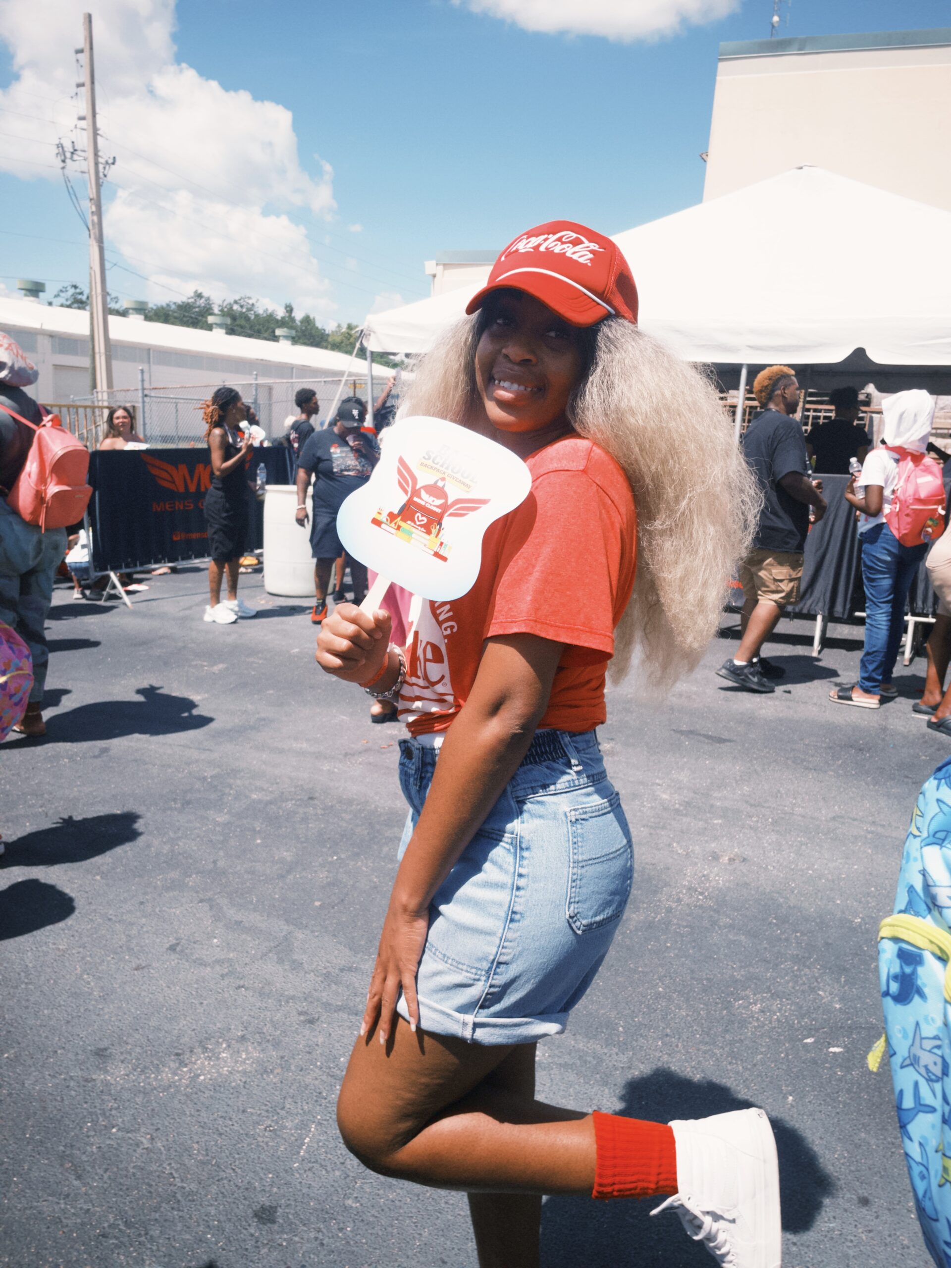 Girl showing off fan with Back to School logo