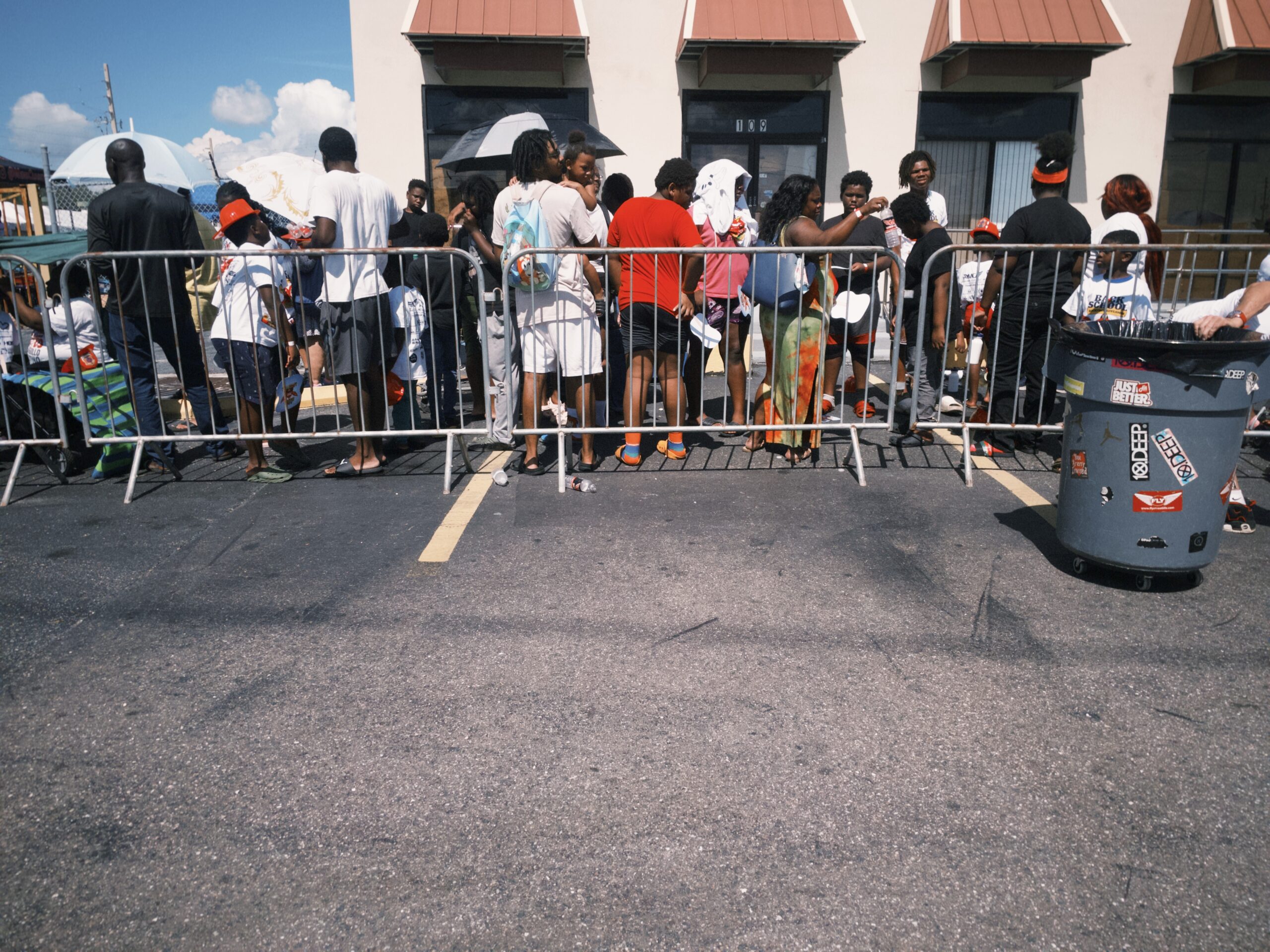 People lining up to get backpacks 